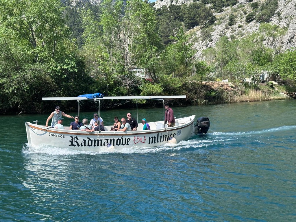 Tour boat with passengers on the Cetina river